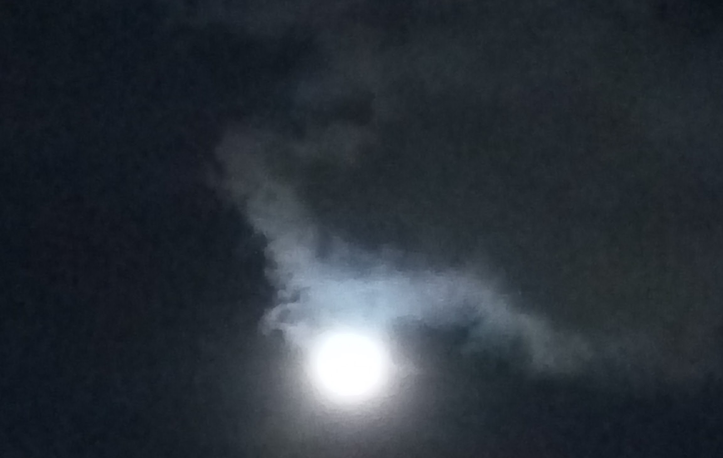 Moon or Mom? - A view of the Clouds unveiling the Moon